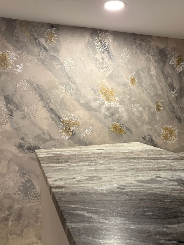 Venetian plaster feature wall with gold and white stencil details