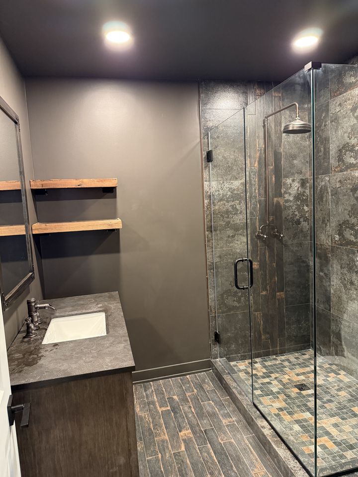 Basement bathroom with stone-look shower