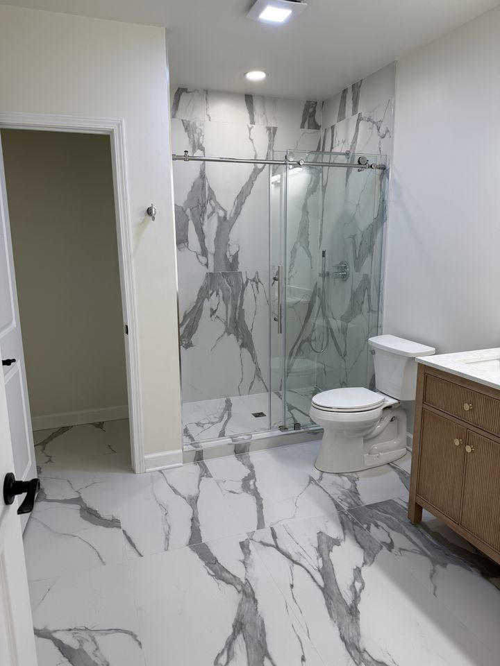 Marble-look bathroom with glass shower