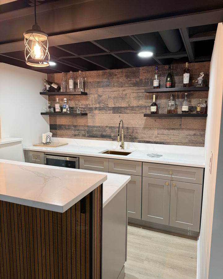 Basement wet bar with open shelving and quartz counters